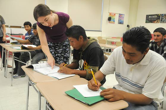 Teacher and adult students in an ESL classroom.