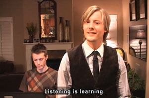 A young man in his living room looks at the screen. The caption reads Listening is learning.