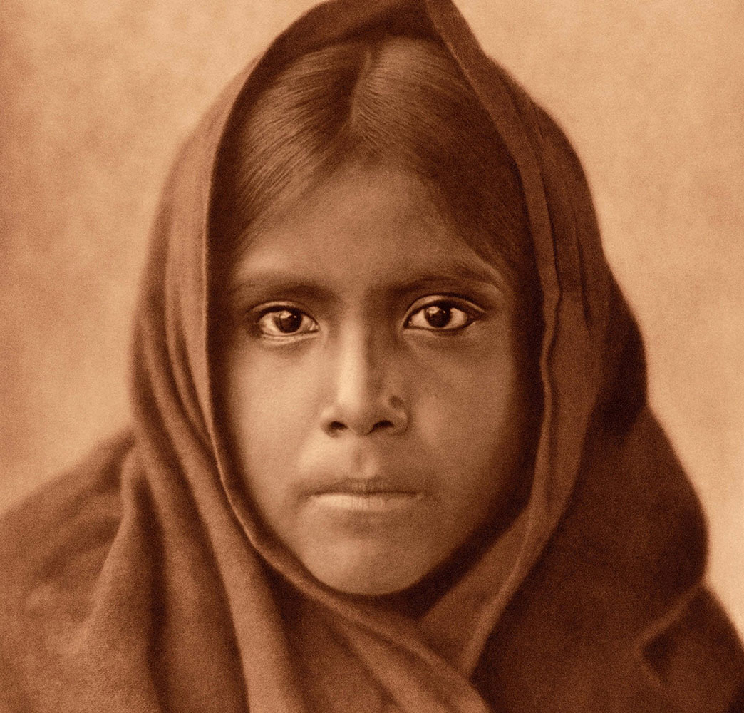 a vintage photo of a young native american girl.